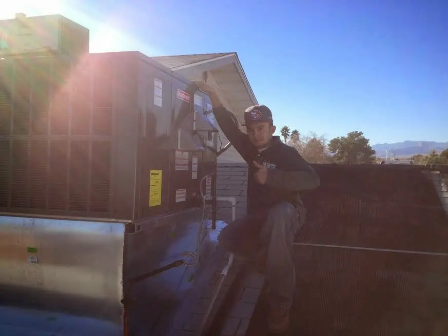 HVAC technician performing HVAC Inspection on a rooftop unit in San Ramon
